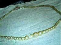 an old beautiful necklace of natural pearls