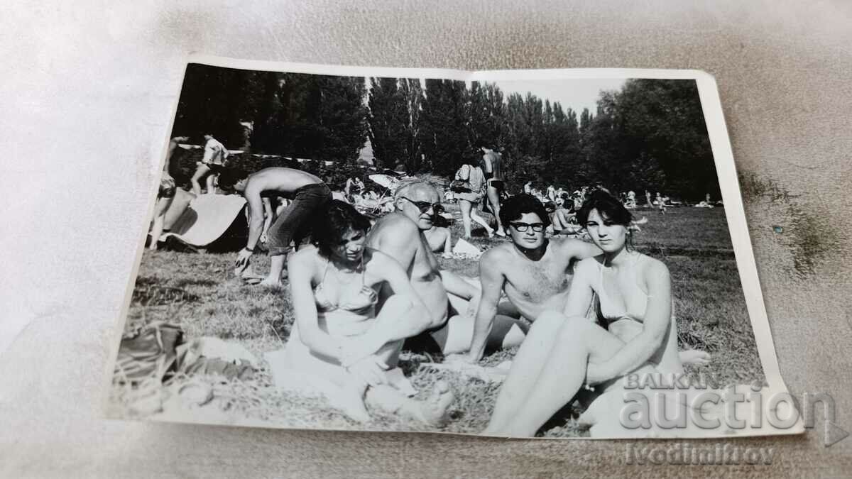 Photo Men and women in swimsuits on the lawn