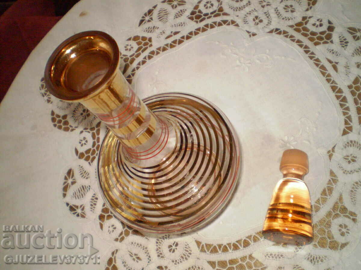 Delivery of Retro colored glass carafe with gold ornaments and stopper Delivery of Retro colored glass carafe with gold ornaments and stopper