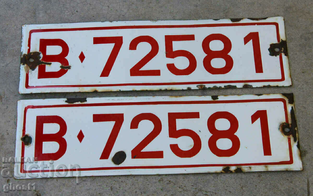 a pair of old military license plates enamelled