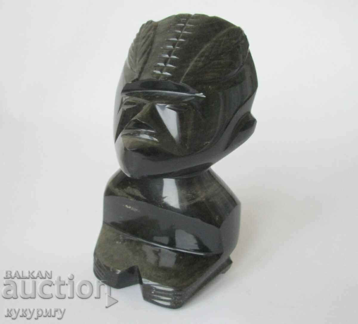 Old statuette figure mask deity from the mineral Obsidian