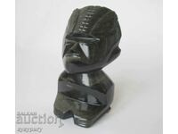 Old statuette figure mask deity from the mineral Obsidian