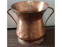 A large solid copper vessel