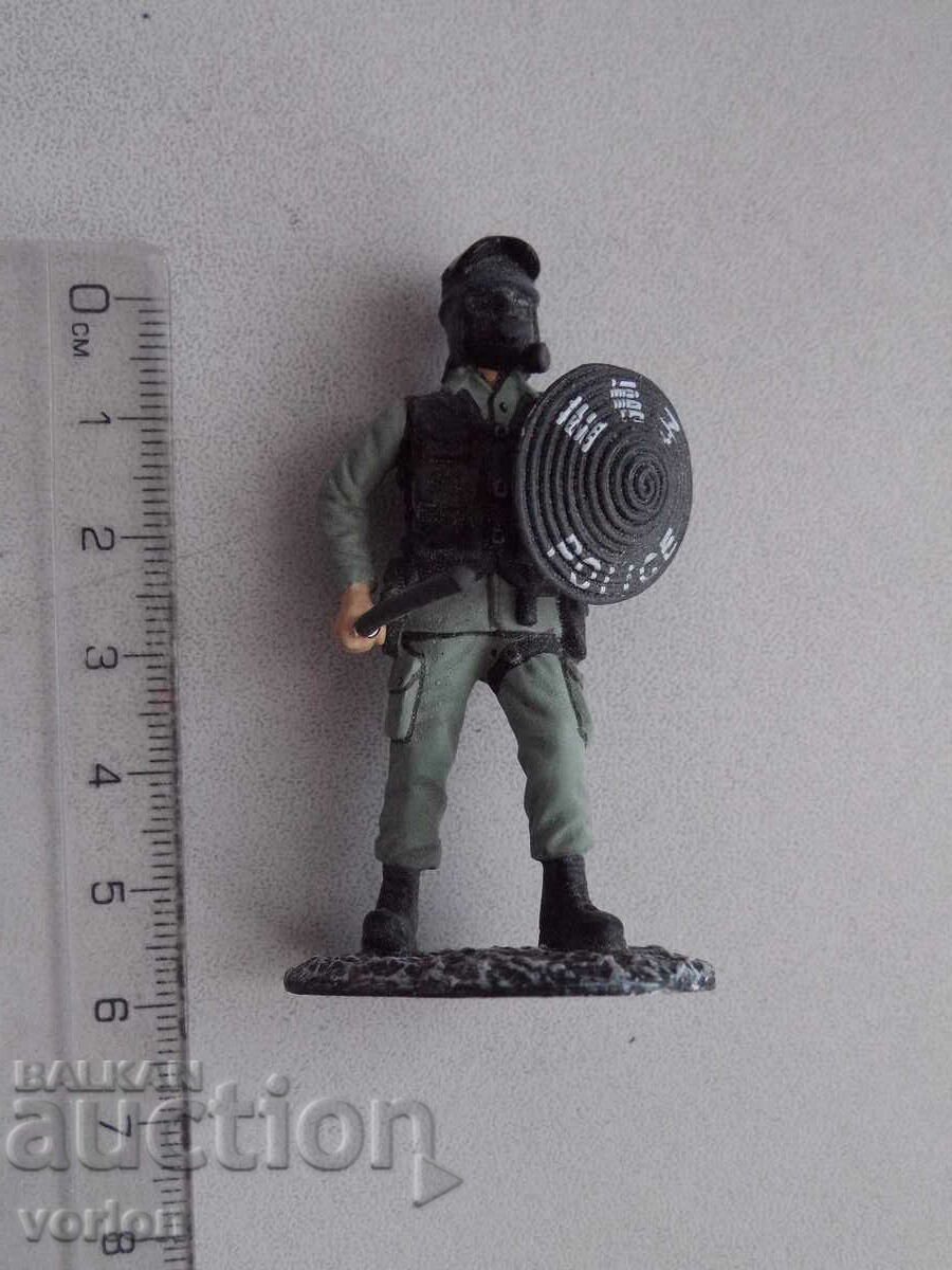 The lead figure is a riot police officer