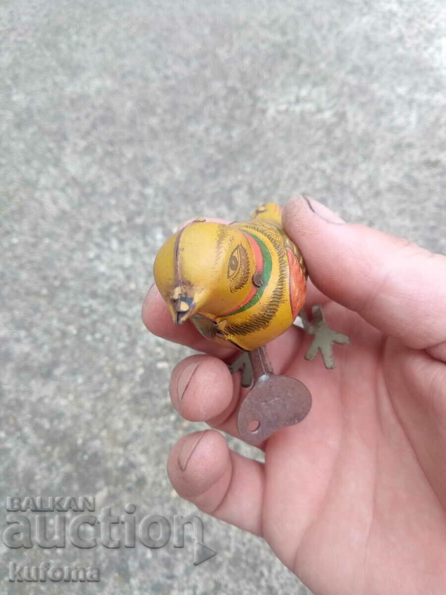 Delivery of Old mechanical tin toy with key Delivery of Old mechanical tin toy with key