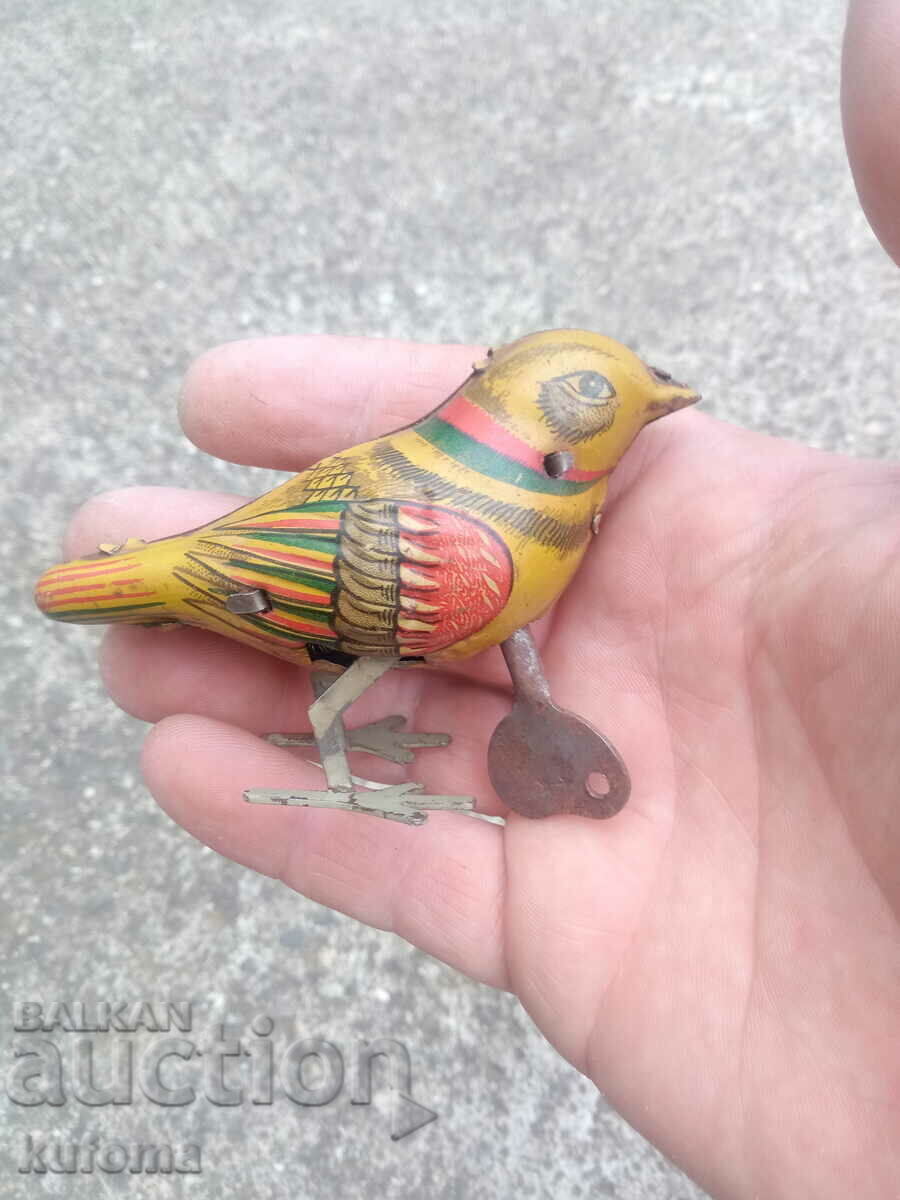 Old mechanical tin toy with key