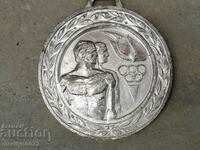 Olympic medal badge of the Central Committee of the DKMS thickly silvered
