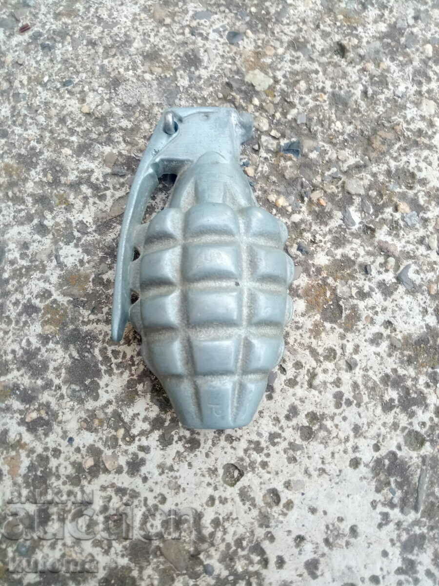 Old aluminum buckle in the shape of a grenade