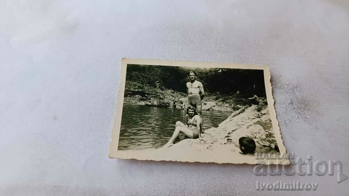 Photo Man and woman in swimsuits by the river
