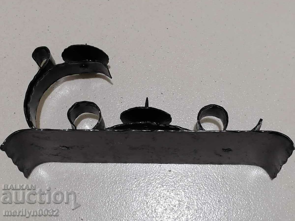 Delivery of An old forged candlestick from a period period candle Delivery of An old forged candlestick from a period period candle