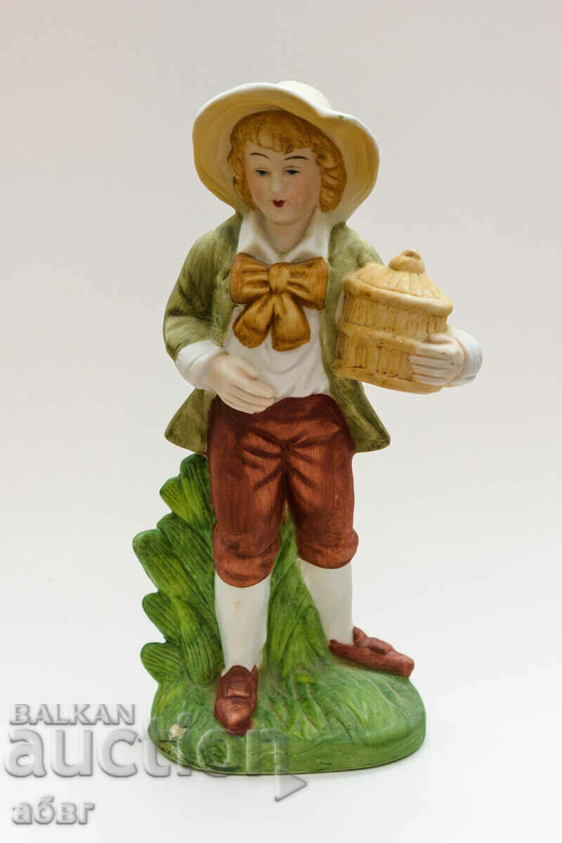 Figure of a young man with a box in his hand