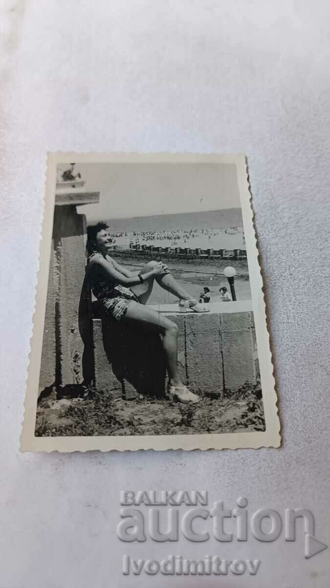 Photo Burgas A young woman in a swimsuit sitting on a railing, 1948