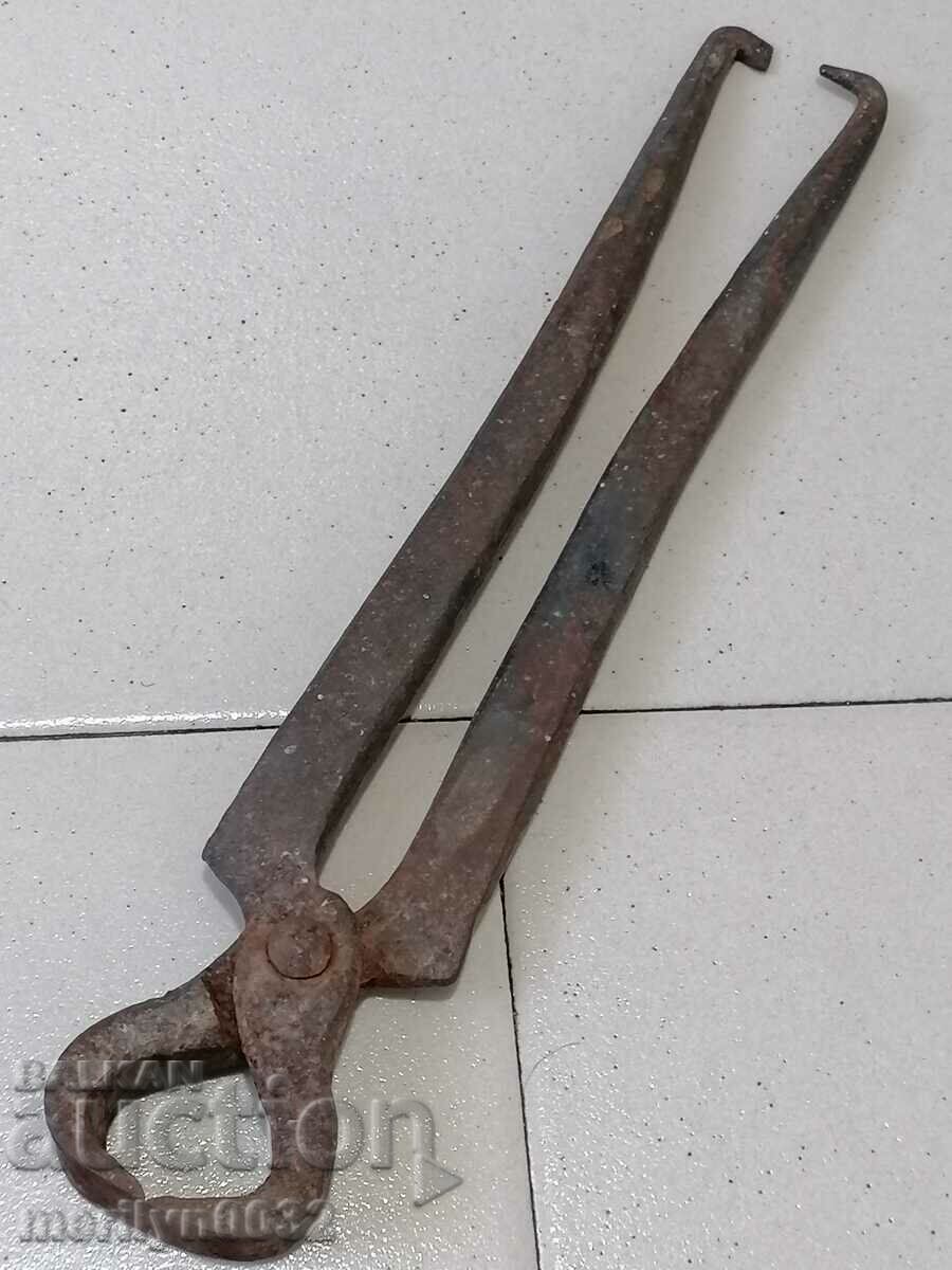 Old tongs, wrought iron, tool corpen
