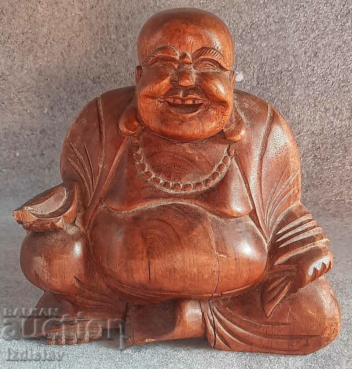 Wooden statue of the happy laughing Buddha Wooden statue of the happy laughing Buddha