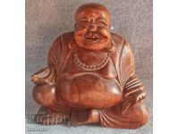 Wooden statue of the happy laughing Buddha