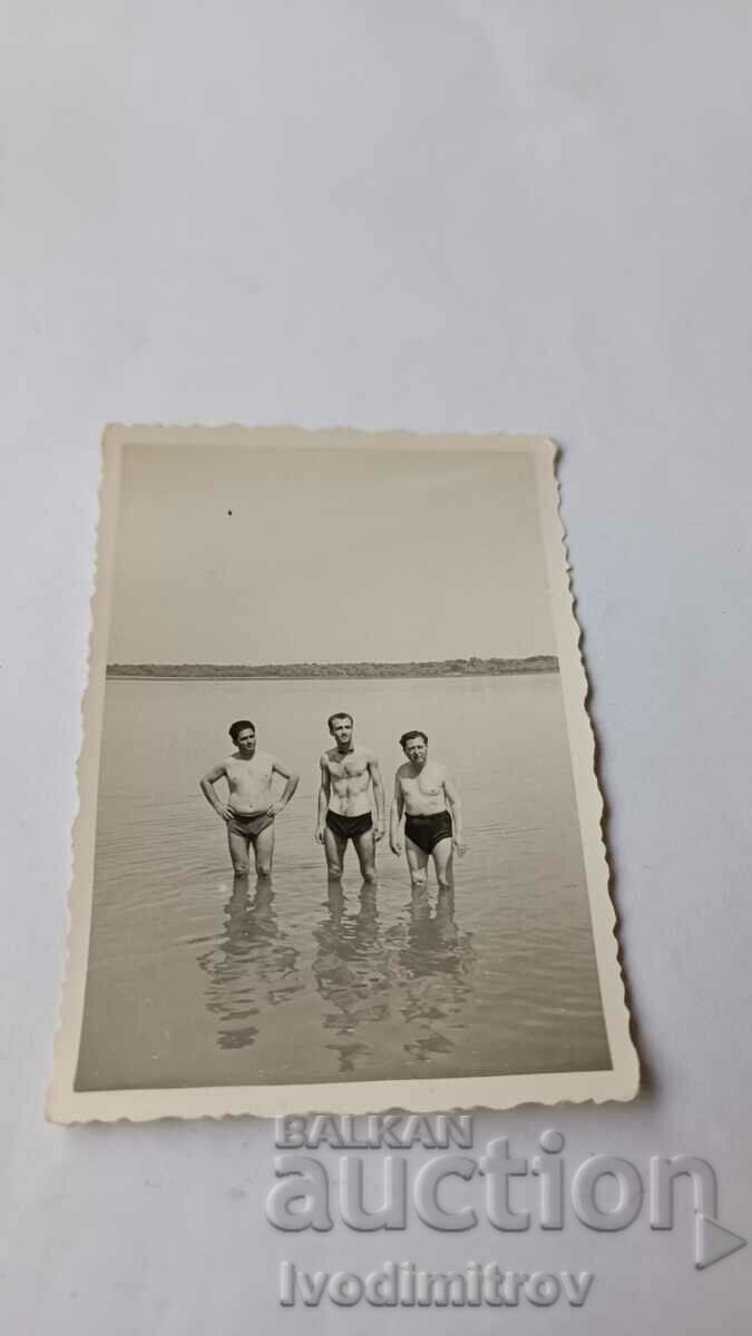 Photo Three men on the beach