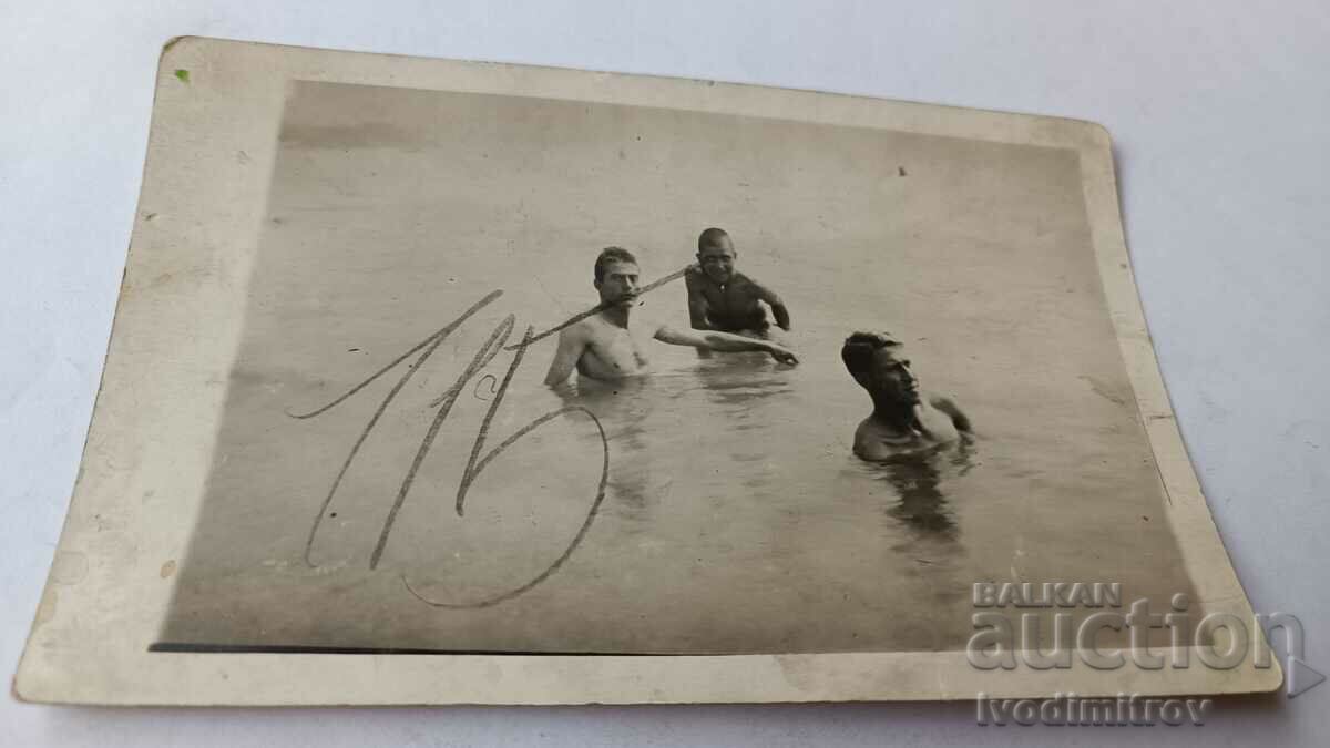 Picture Three young men in the sea