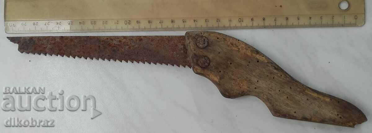 old antique wood saw with wooden handle