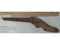 old antique wood saw with wooden handle