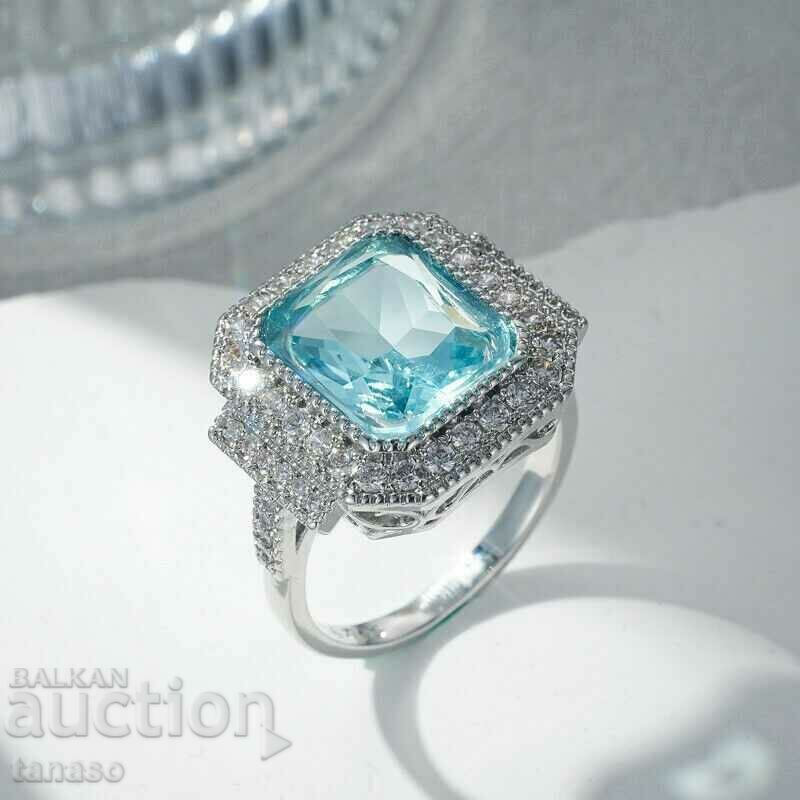 Ring with aquamarine and zircons