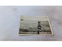 Снимка Младо момиче седнала в лодка на брега на морето