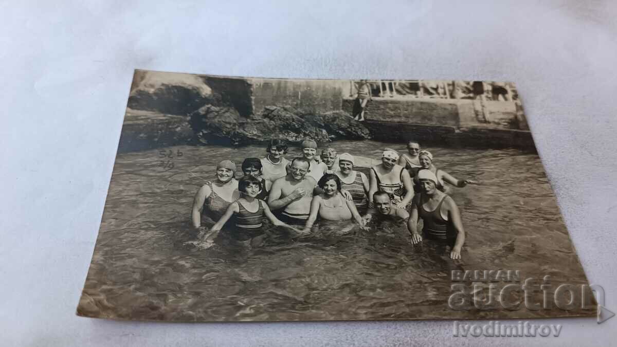 Picture Men and women in a pool of a river