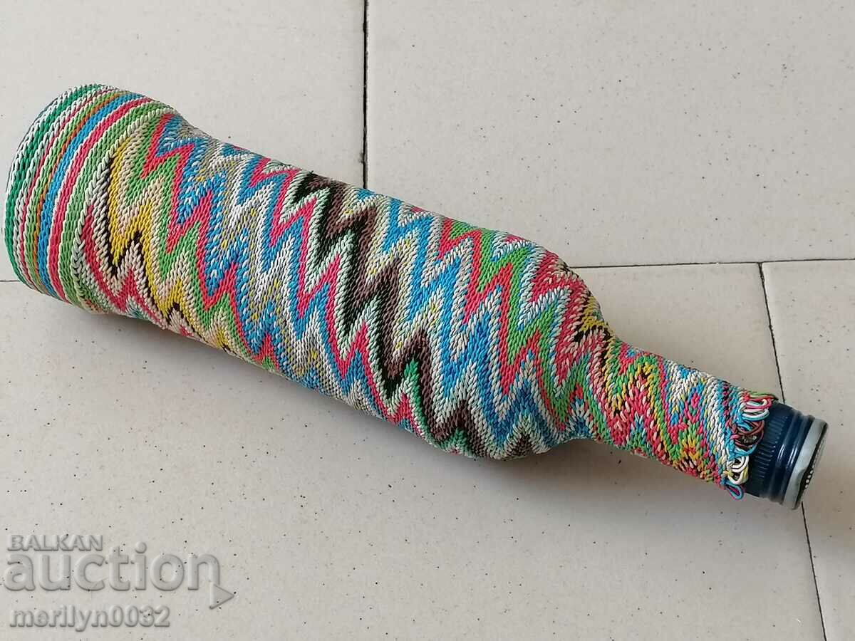 Auction Old glass bottle with colorful braid bottle, glass Auction Old glass bottle with colorful braid bottle, glass