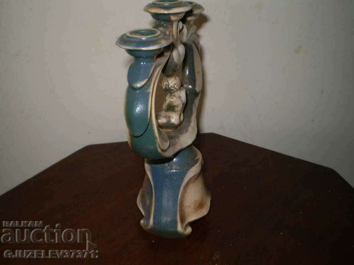 Delivery of Retro candlestick with a child figurine, colored ceramics Delivery of Retro candlestick with a child figurine, colored ceramics