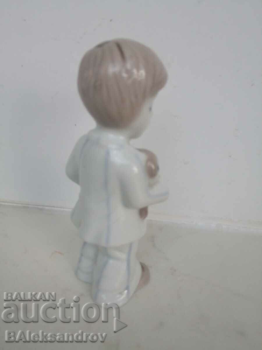 Porcelain figurine, a boy with a cache with price 12.00 BGN | € 6.14 Porcelain figurine, a boy with a cache with price 12.00 BGN | € 6.14