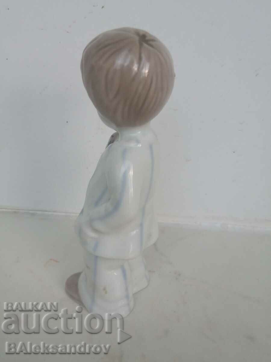 Auction Porcelain figurine, a boy with a cache Auction Porcelain figurine, a boy with a cache