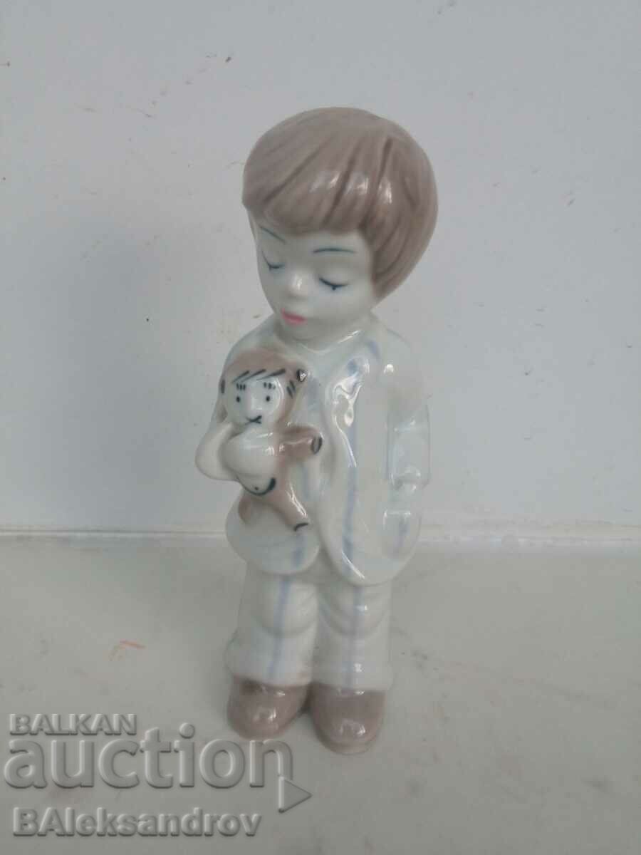 Porcelain figurine, a boy with a cache