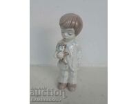 Porcelain figurine, a boy with a cache