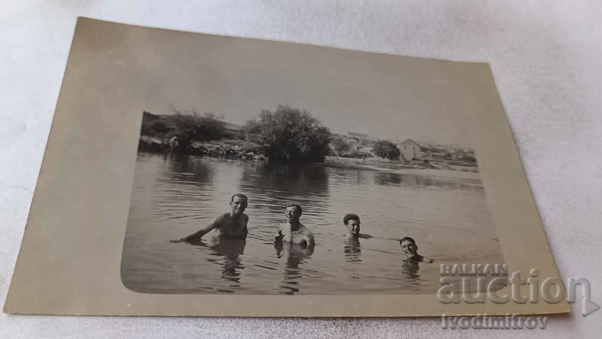 Photo Four young men bathing in the river
