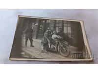 Photo Two officers and children on a vintage motorcycle with registration number WH-13012