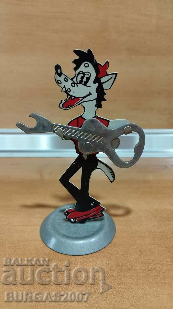 Old metal figure with a guitar opener, from "Well, guess!"
