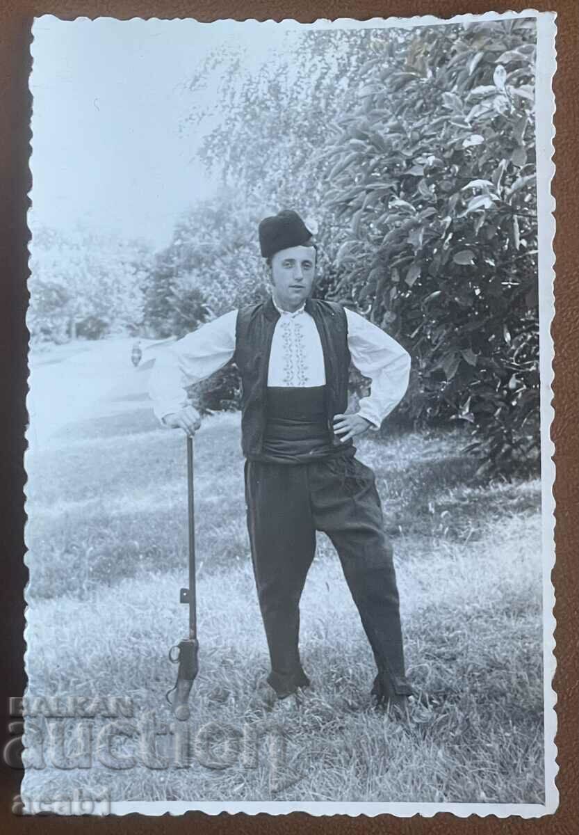 A man in a costume and a rifle "Martina"