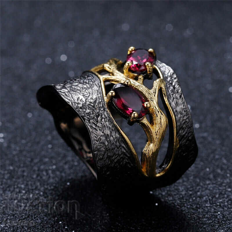 Auction Ring with a red garnet, rhodium Auction Ring with a red garnet, rhodium