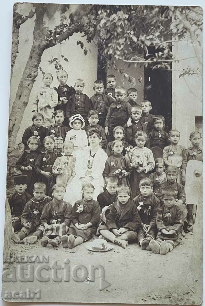 Pupils and the Teacher in front of the School
