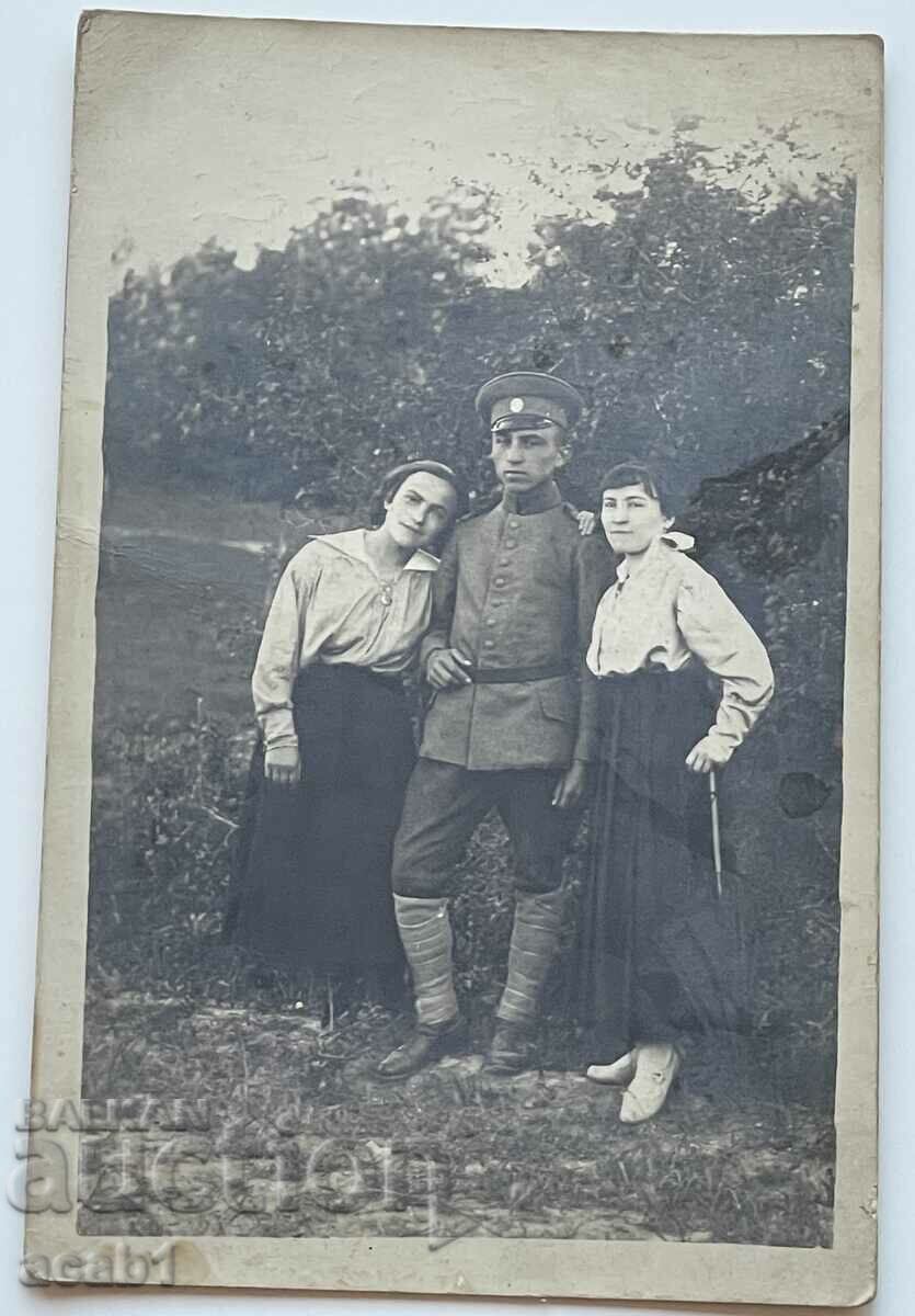 A soldier and two ladies