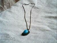 a beautiful soft silver necklace with a soft torcoise