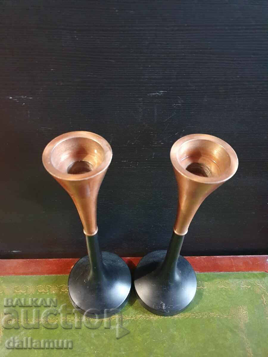 a pair of metal candlesticks