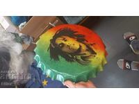 Metal sign in the shape of a Bob Marley cap