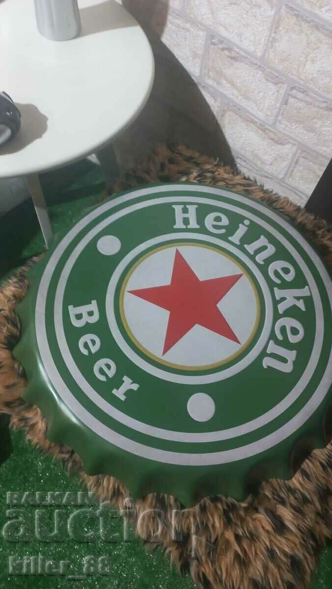 Metal sign in the shape of a Heineken beer cap