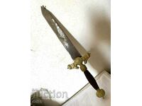 Old beautiful steel dagger with brass