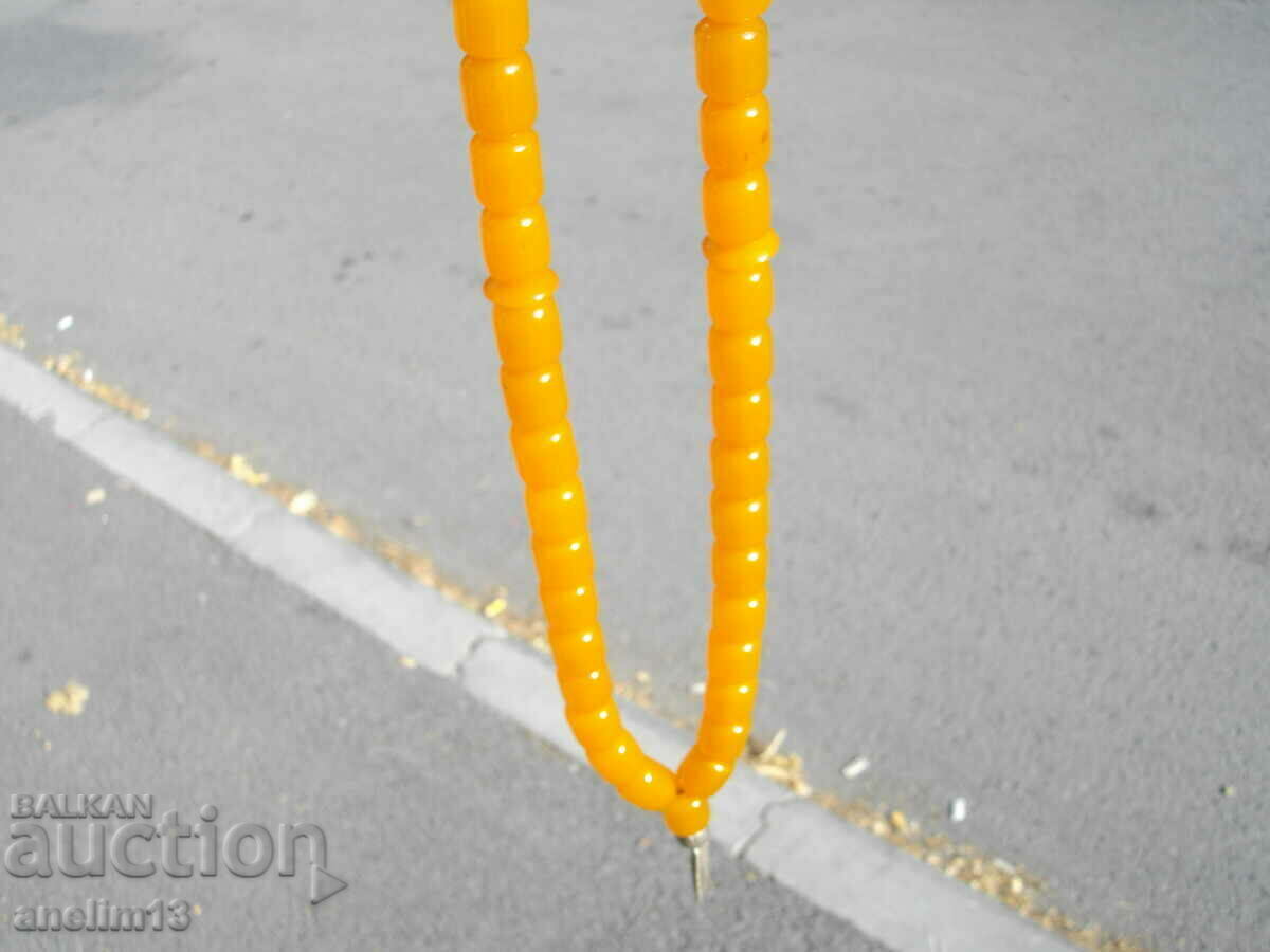 Delivery of OLD BAKELITE AMBER CATALINE ROSARY WITH SILVER TASSEL