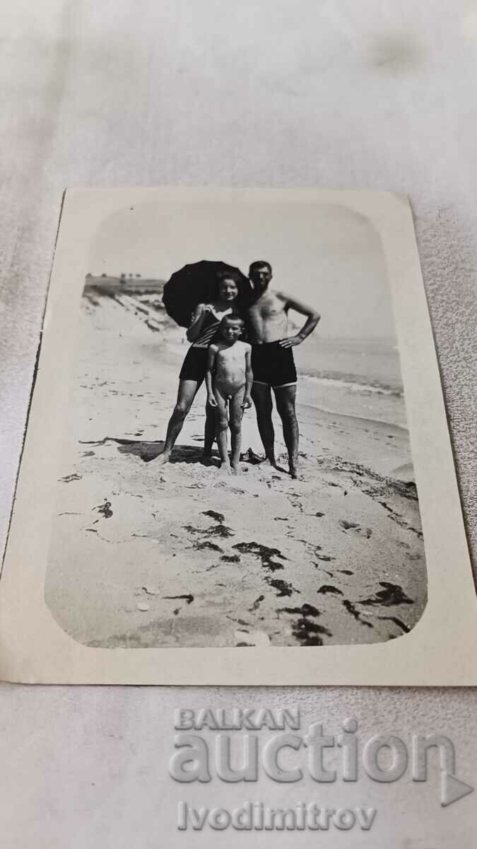 Ms. Byala Man woman with retro swimsuit and little boy on the beach