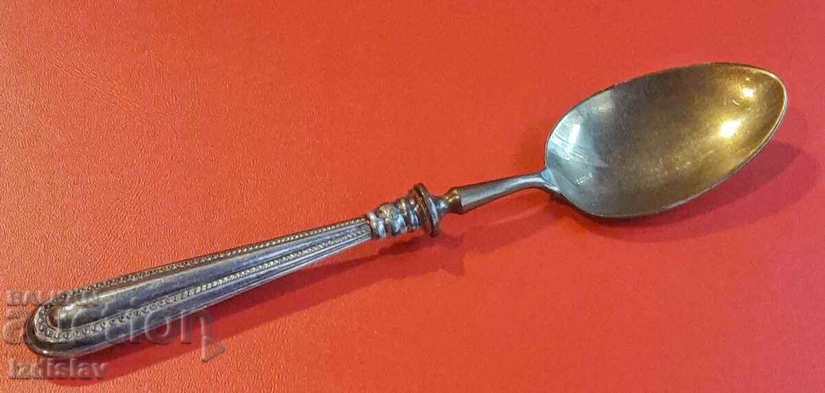 Antique spoon with silver handle.