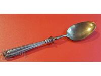 Antique spoon with silver handle.