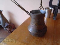 a large copper cauldron, massive, polished,