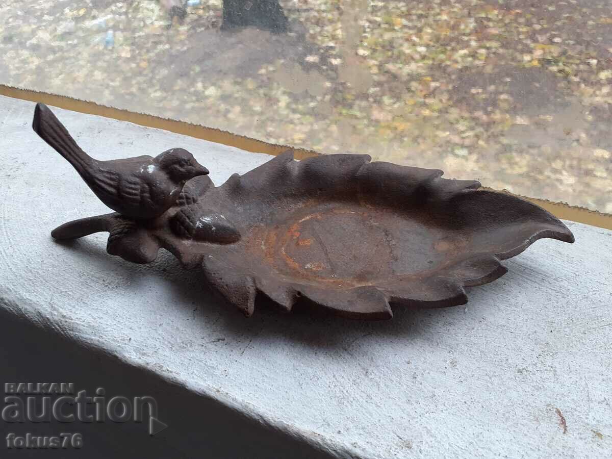 Old small cast iron plate with chicken